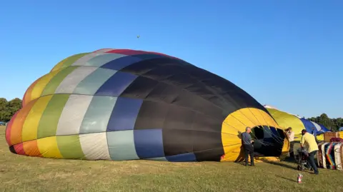 Laura Foster/BBC  General view of a hot air balloon being inflated at Northampton's Racecourse