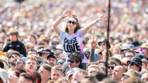 Getty Images A woman in the crowd dancing at Glastonbury