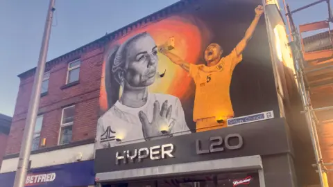 Mural on the wall of a shop of footballer Alex Greenwood