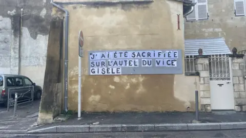 Marianne Baisnée/BBC The words of Gisèle Pelicot - "I was sacrificed on the altar of vice" - have been put up in a street in Avignon