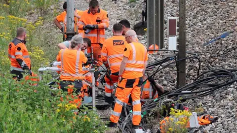 Getty Images Men at work on railway tracks