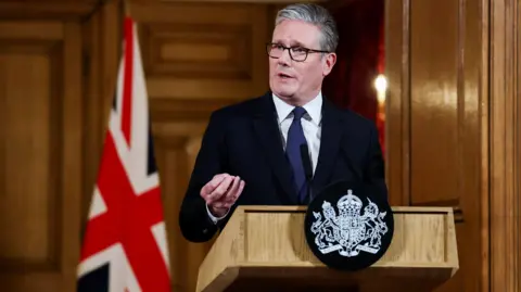 Reuters Britain’s Prime Minister Keir Starmer answers questions from the press after delivering a statement inside No. 10 Downing Street