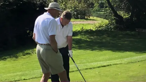 England and Wales Blind Golf Mike Tomlinson being lined up by a volunteer guide in the England vs Scotland match