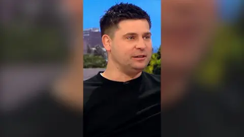 Ben Youngs wears a black pullover whilst sitting in the BBC Breakfast studio