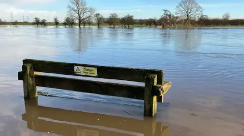 BBC A view of the River Trent with water over its banks, on Stoke Lane in Burton Joyce.