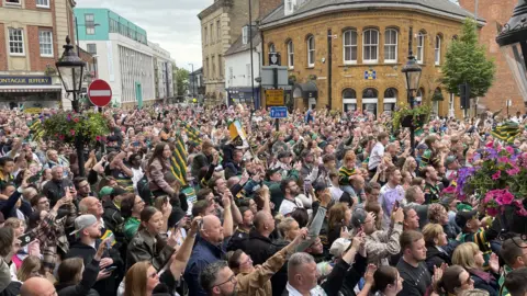 James Burridge/BBC Thousands of fans in Northampton for the Saints Premiership celebratory parade
