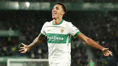 Alvaro Rodriguez celebrates a goal for Elche with his arms out wide