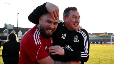 Neil Gibson (right) celebrates with Connah's Quay defender Kai Edwards