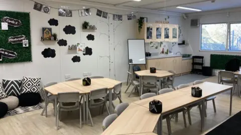 A mobile classroom, showing chairs and tables