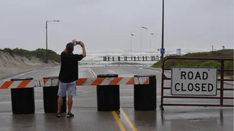 AFP/Getty A resident photographs the beach in Corpus Christi