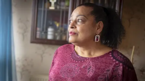 Phil Coomes/BBC Ruby, a sexual abuse survivor, in her home in north London