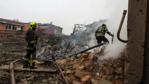 Reuters Emergency workers look through rubble after the missile strike in Odesa