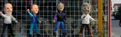 AFP Pinatas depicting Mexican presidential candidates (L-R) Jose Antonio Meade (PRI, PVEM and Nueva Alianza parties), Ricardo Anaya (PAN-PRD-Movimiento Ciudadano parties), independent Jaime "el Bronco" Rodriguez Calderon, and Andres Manuel Lopez Obrador (Morena, PT and PES parties) are displayed for sale in a street in Ciudad Juarez, Mexico on June 13, 2018,