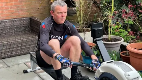Bekki Thomas / BBC Gary Terry on a rowing machine