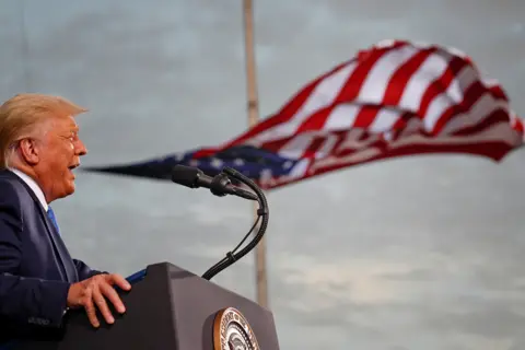 Tom Brenner / Reuters US President Donald Trump speaks, with a flag behind him, during a campaign rally at Cecil Airport in Jacksonville, Florida, on 24 September 2020