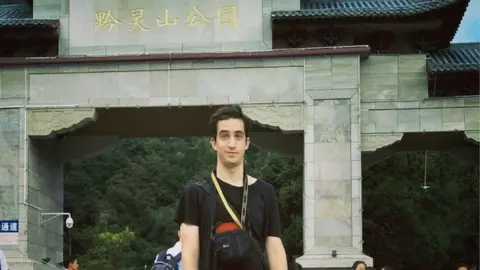 PETER HANCOCK Phillip Hancock posing in front of a tourist attraction in China