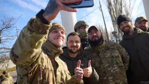 Reuters The president poses for a picture with soldiers