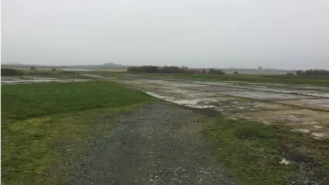 Land next to Mona airfield