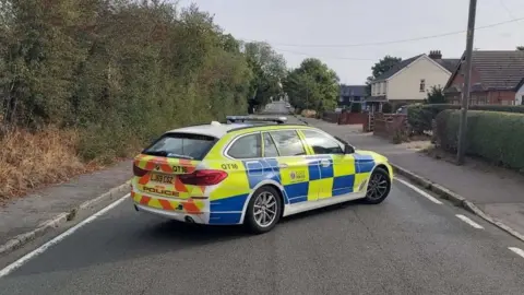 A police care in London Road, Kelvedon, Essex