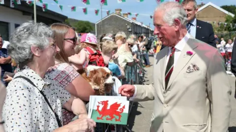 PA Media The Prince of Wales meets local residents during a walk