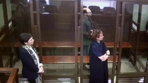 Moscow court handout Elena standing beside her son as he is sentenced