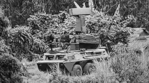 UN A black and white screenshot of a short-range air defence system - a weapon that resembles a tank.