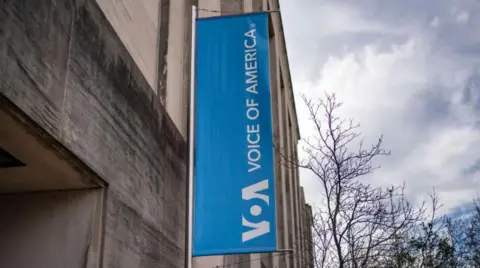 Signage for US broadcaster Voice of America is seen in Washington, DC