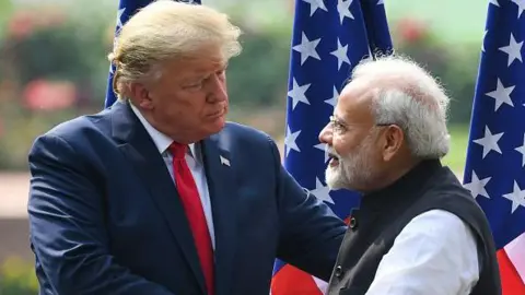 Donald Trump (L) shakes hands with Prime Minister Narendra Modi during a joint press conference at Hyderabad House in New Delhi on February 25, 2020