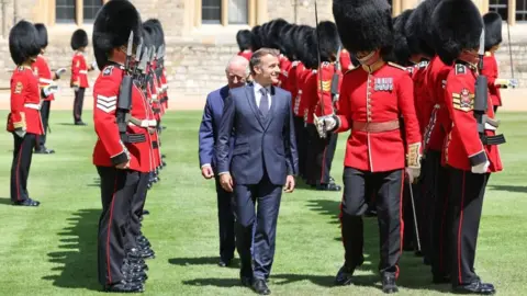 Reuters French President Emmanuel Macron and King Charles inspect the Guard of Honour at Windsor Castle.