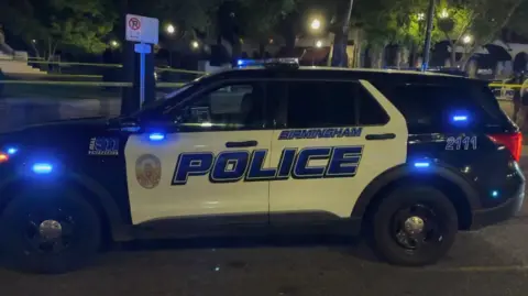 Birmingham Police A police car at the scene of Saturday night's shooting in Birmingham, Alabama