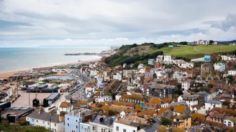Getty Image An English seaside town. It has a beach and pier.