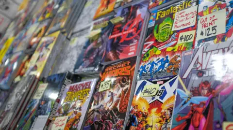 Getty Images A variety of superhero comic books arranged on a shelf