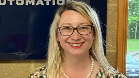 Guy Campbell/BBC The Labour candidate wearing glasses and a necklace