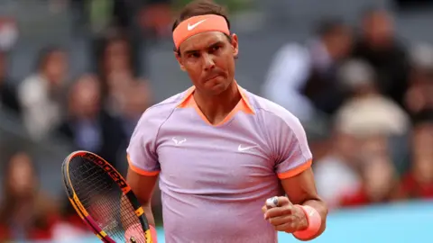 Rafael Nadal celebrates winning a point at the Madrid Open