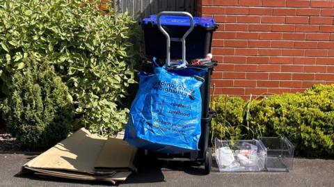 Uncollected recycling and food waste on a Denbighshire street