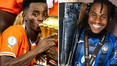 A split image shows Simon Adingra wearing an orange Ivory Coast shirt and kissing the Africa Cup of Nations trophy while Ademola Lookman smiles broadly in a black and blue Atalanta shirt while holding the Europa League trophy