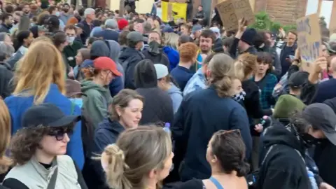 BBC/Andy Gill A large crowd gathers on Overbury Street in Liverpool