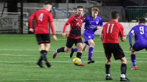 Claire Kirkpatrick More action from the south of Scotland as two teams in red and blue - Lochar Thistle and Lochmaben - go head to head