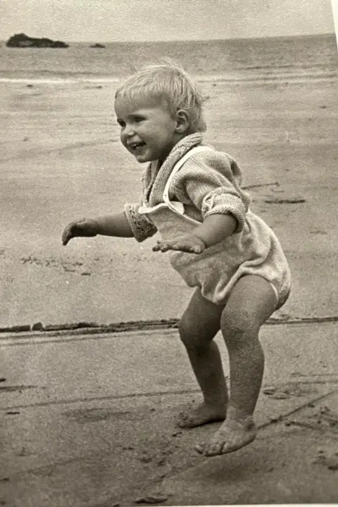 Gatt family Katie as a baby on the beach in Alderney