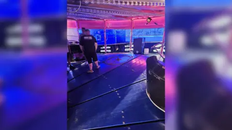 A fairground waltzer ride with one car detached