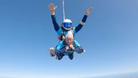 Manette Baillie and instructor skydiving