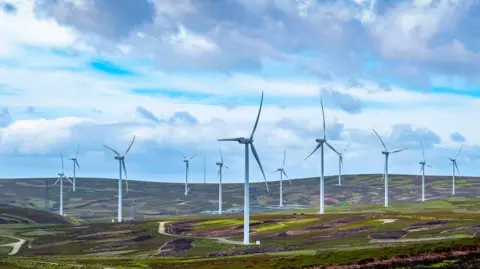 EDF power solutions UK A wind farm project in the Borders on a wide open landscape with numerous turbines.