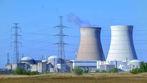 Cooling towers of the Doel Nuclear Power Station, nuclear power plant and high-voltage electricity pylons in the Antwerp harbour, Flanders, Belgium