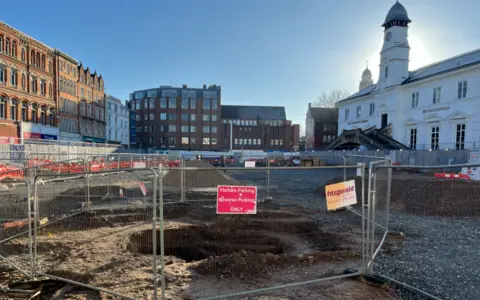The cleared area of Leicester Market with fences around holes in the ground
