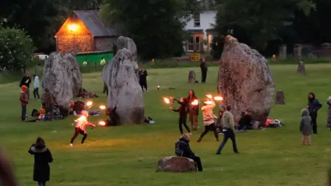 Reuters Revellers celebrate the Summer Solstice, despite official events being cancelled amid the spread of the coronavirus disease (COVID-19), in Avebury