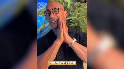 Instagram/@therock A screenshot of Dwayne Johnson's video to the students. The background is a tropical beach and the caption reads "You're welcome!"