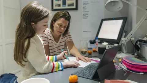 Getty Images A child and her mother home schooling