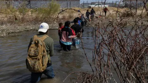 Getty Images Migrants at the US-Mexico border near El Paso on 7 March