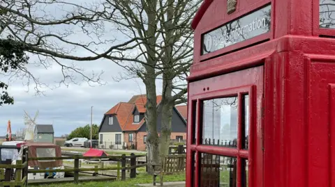 Mike Liggins/BBC A visitor information centre in a red phonebox on the Norfolk Broads