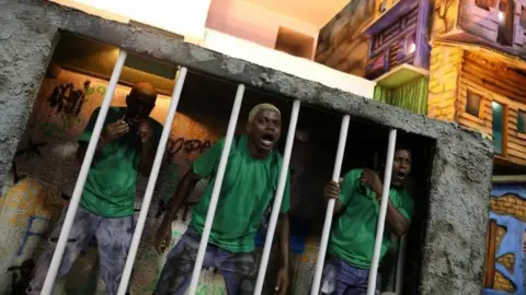 Reuters Performers dressed as prisoners at Rio Carnival